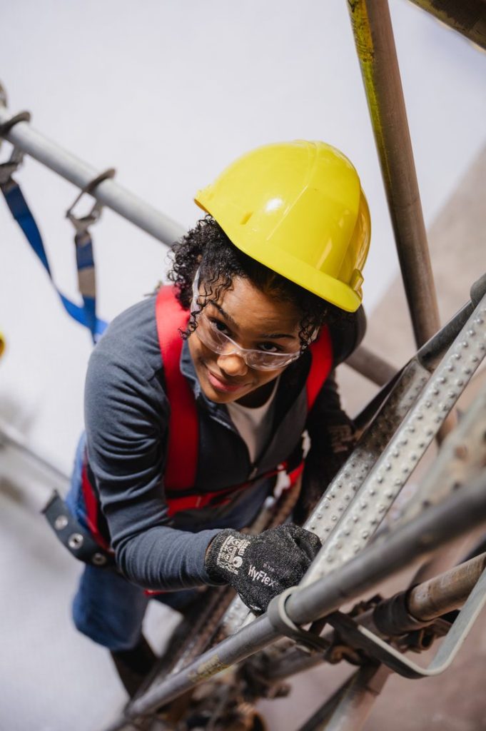 a portrait of a young apprentice in a yellow hard hat